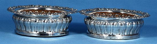 A pair of George IV silver wine coasters, Diameter 6 ¾”/170mm Height 60 Total weight inc bases 19.6ozs/557grs